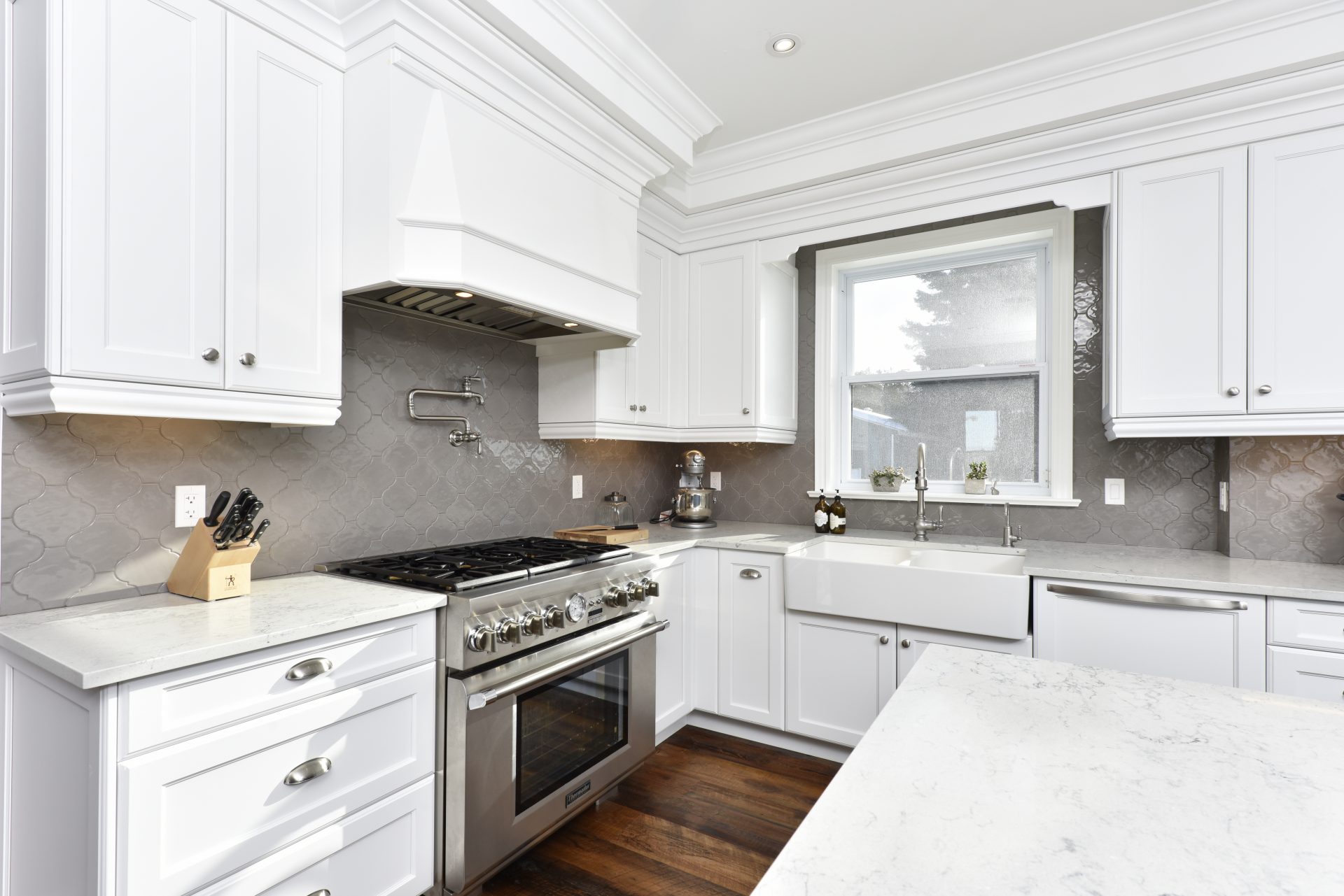 Classic white kitchen with gray tile backsplash