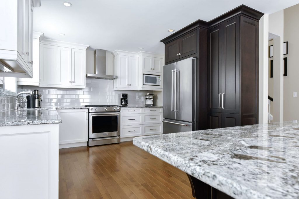White kitchen with some dark cupboards and stainless appliances