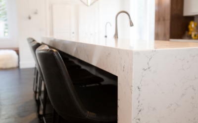 grey veining in white quartz counter top with black leather counter chairs | home value blog