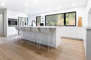 u-shaped kitchen with white island and stools