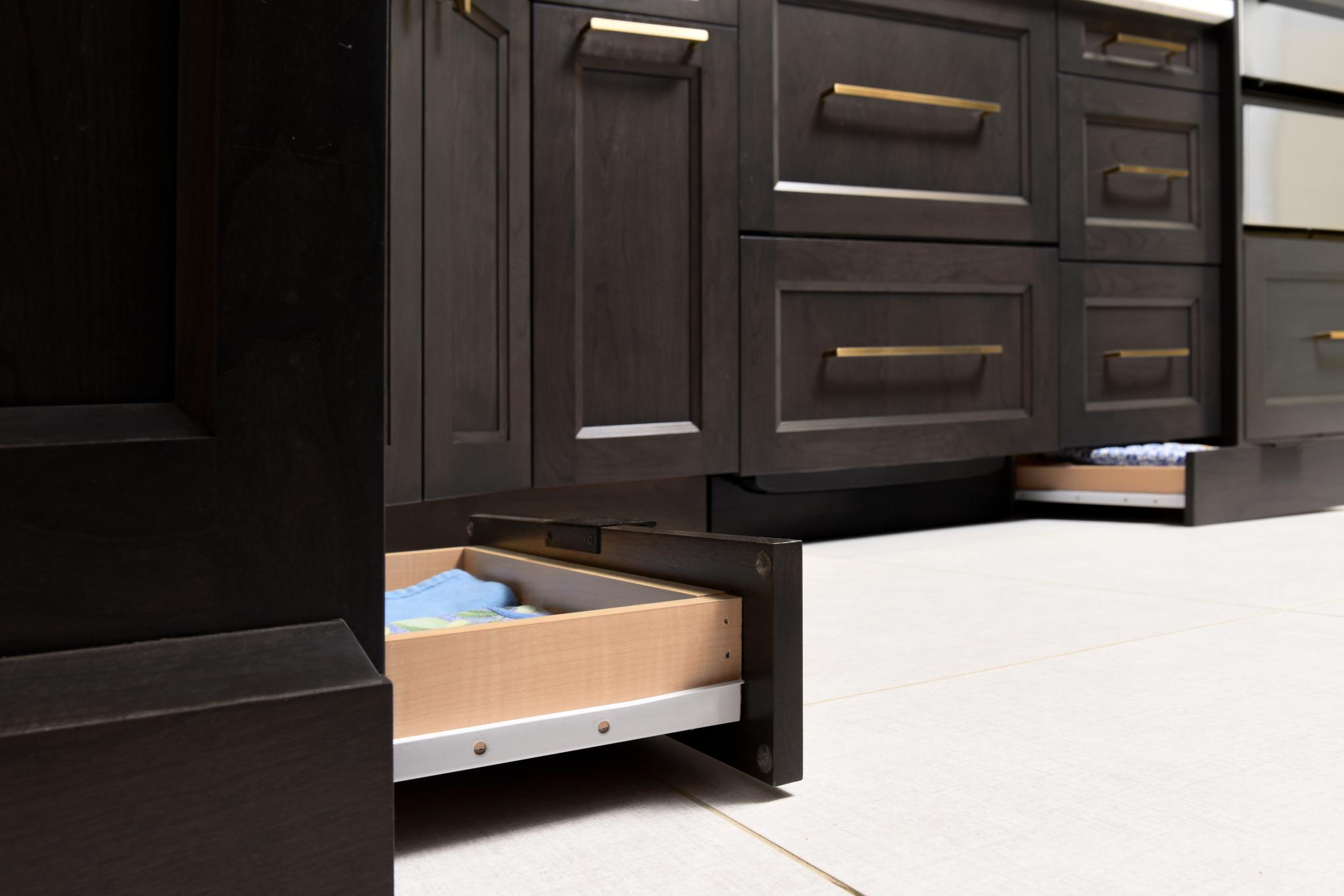 Drawers that sit under the kick back of your cabinets