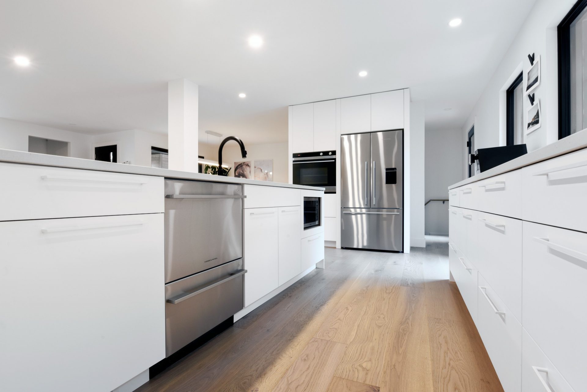 Minimalist white kitchen with flat-panel cabinets