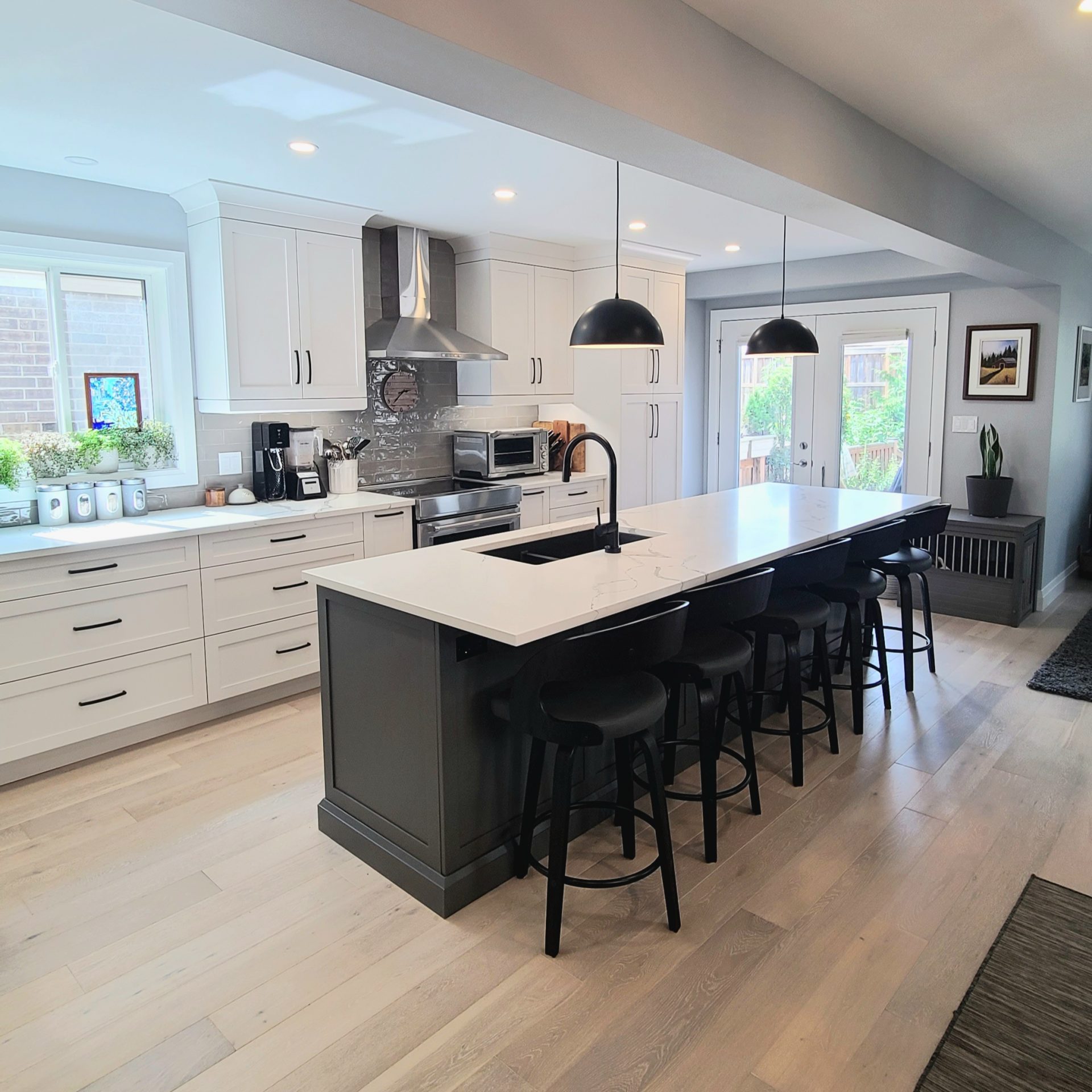 White kitchen with blue island and black accents.