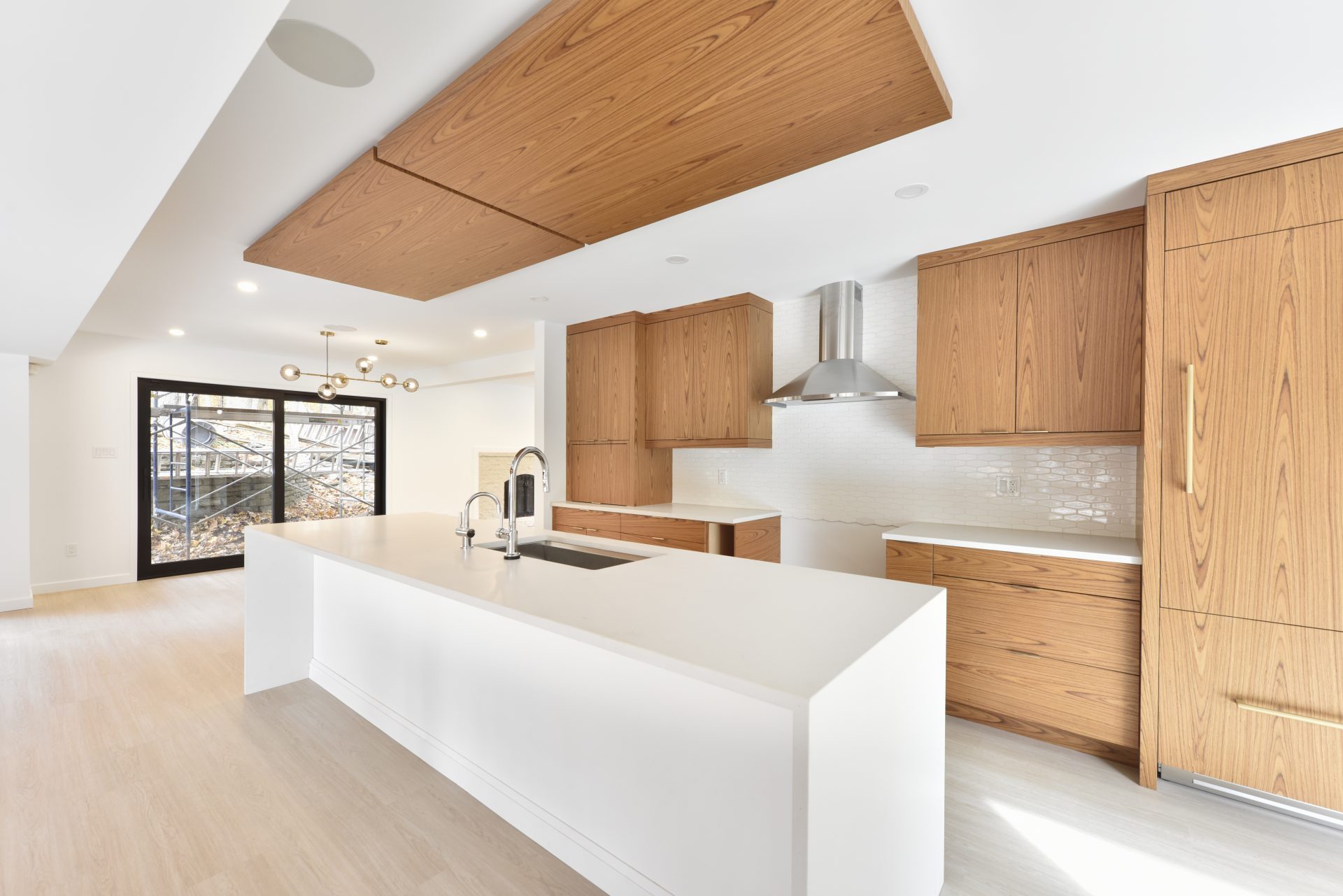 Modern open kitchen with warm wood and white clean lines.
