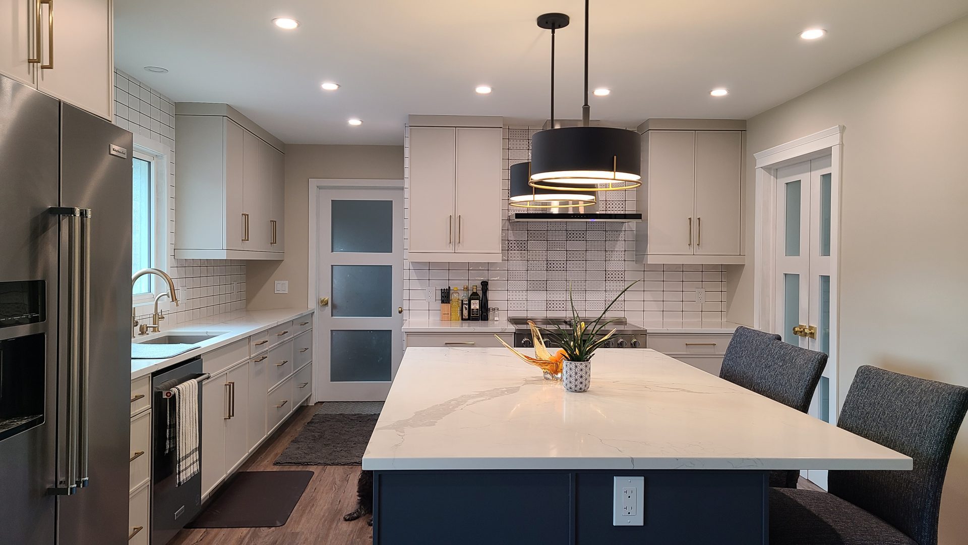 White kitchen with blue island.
