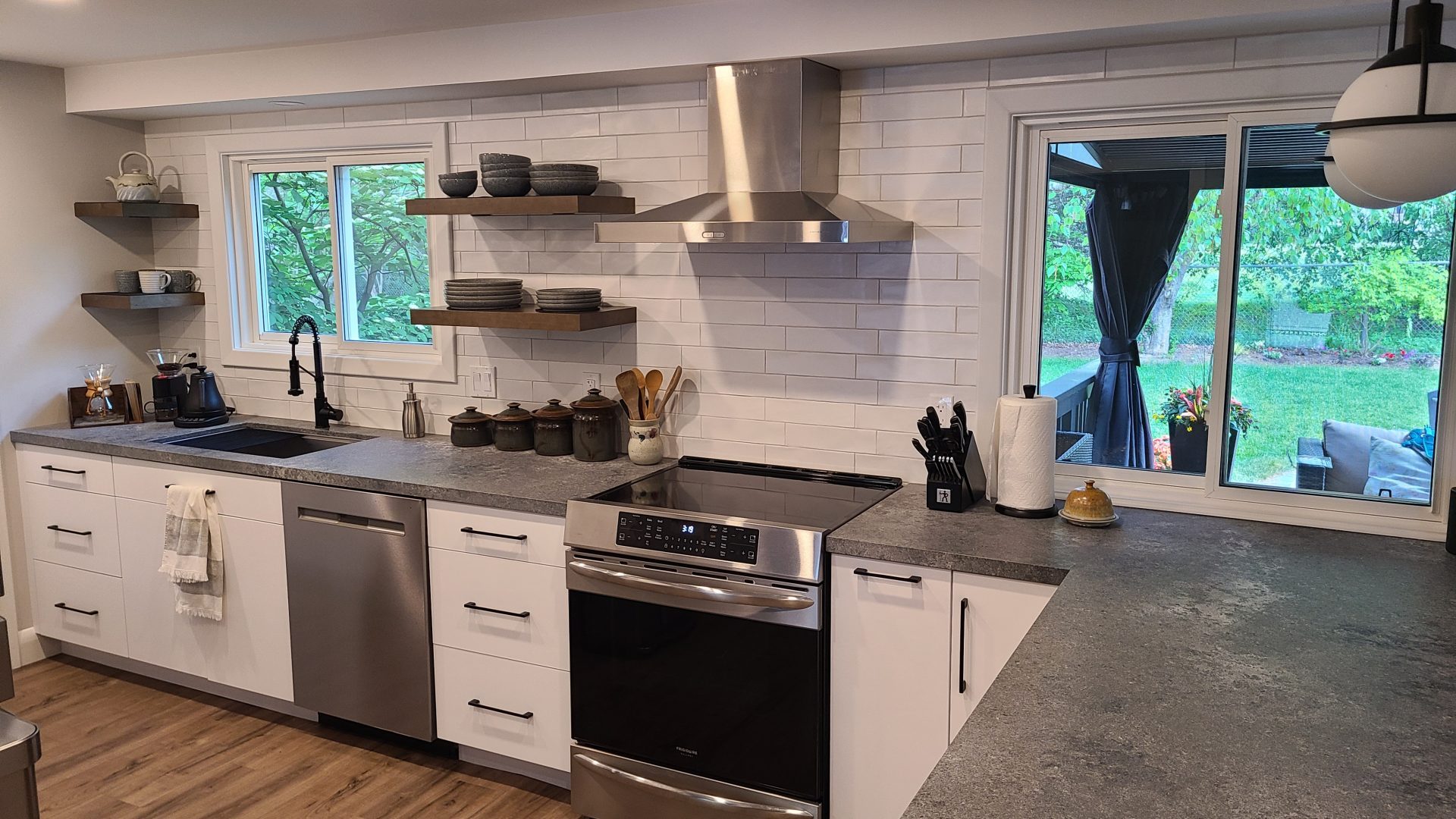 White kitchen with modern dark countertops.